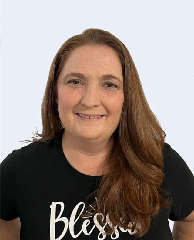 A woman wearing a black t - shirt that says blessings.